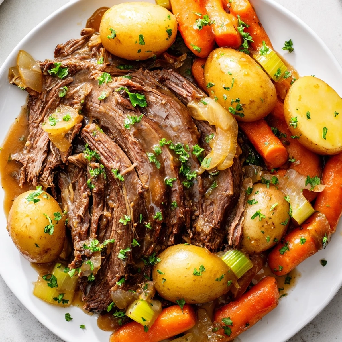 Hearty Slow Cooker Beef Roast Dinner served with gravy, baby potatoes, and carrots for a cozy family meal.