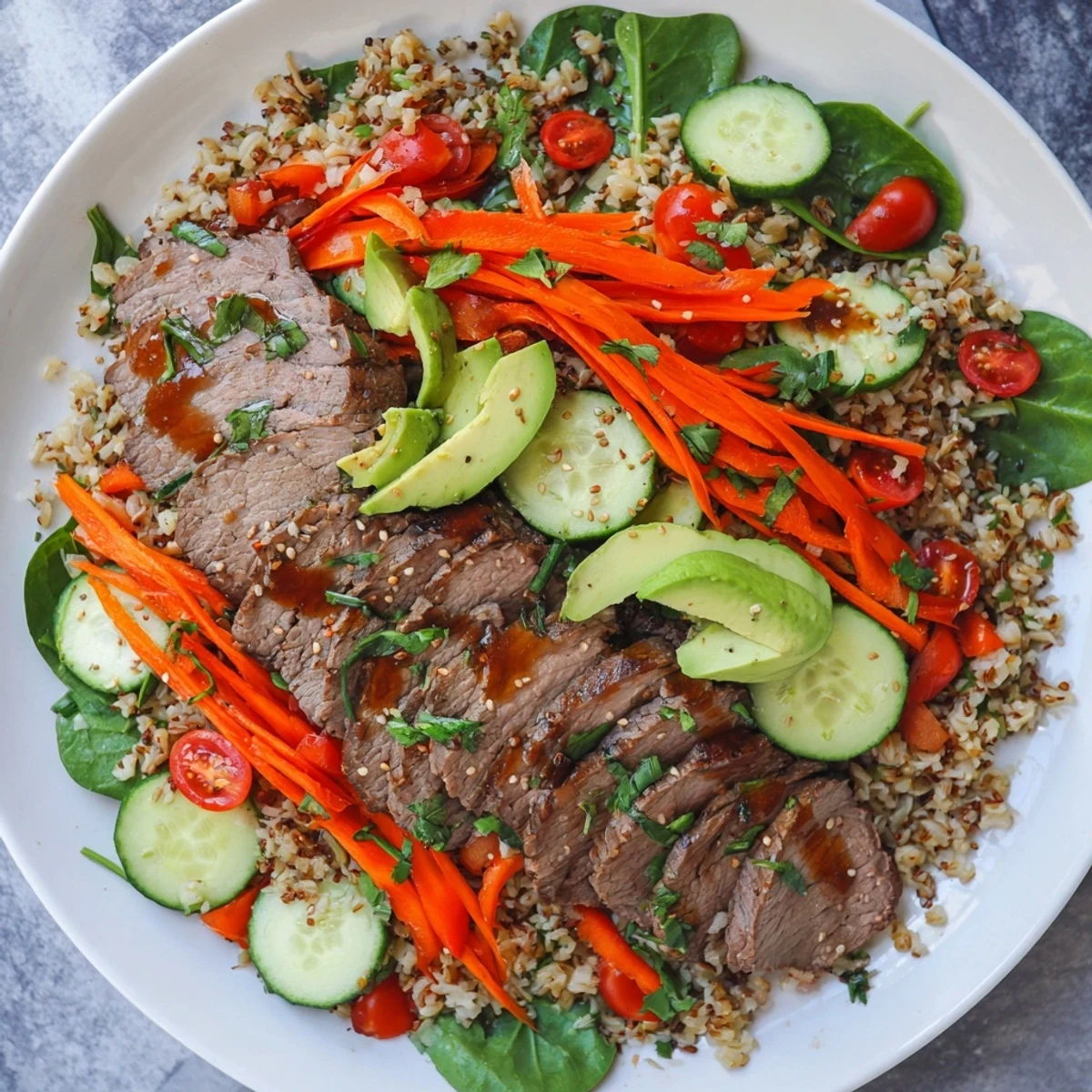 A vibrant Beef Meal Bowl with Grains, featuring tender marinated beef, fluffy quinoa, and crisp veggies like bell peppers and cucumbers, all drizzled with a zesty lemon dressing.  