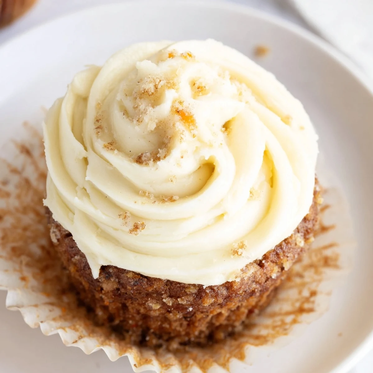 Freshly baked Carrot Cake Cupcakes with cream cheese frosting, featuring moist crumb and cinnamon spice aromas.  
