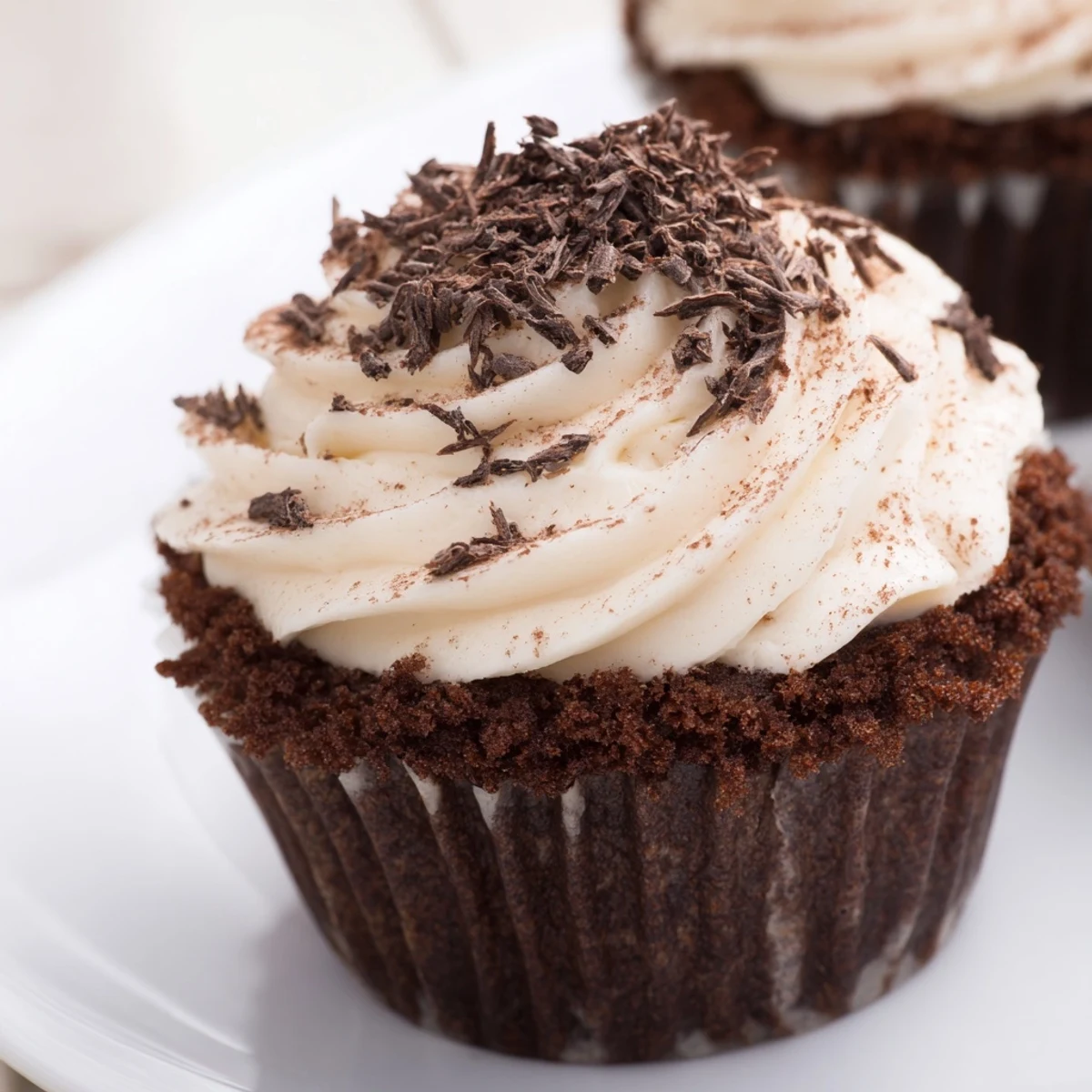 Decadent chocolate tiramisu cupcakes topped with fluffy mascarpone frosting and dusted cocoa powder