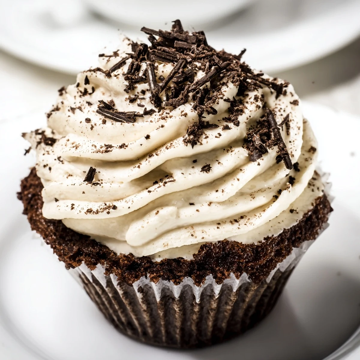 Chocolate tiramisu cupcakes with coffee-infused sponge and swirled mascarpone topping garnished with chocolate