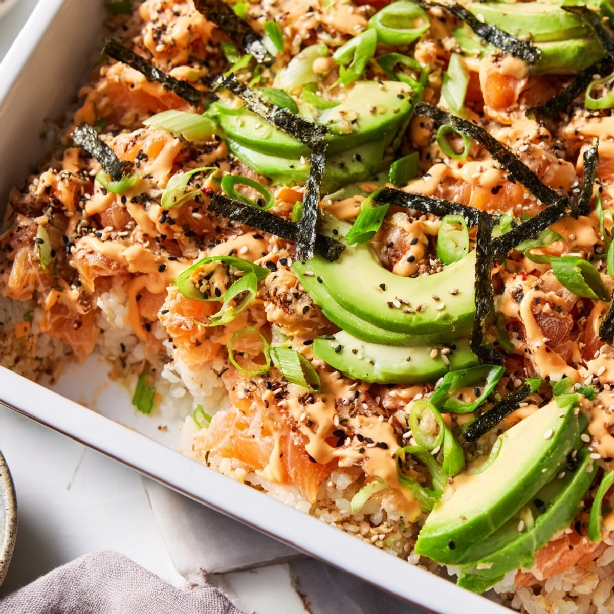 Warm Japanese salmon sushi bake casserole with furikake and nori strips