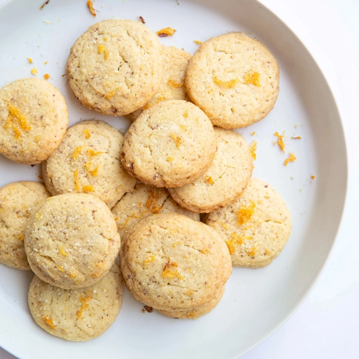 Freshly baked orange clove cookies with lightly golden edges cooling on a wire rack