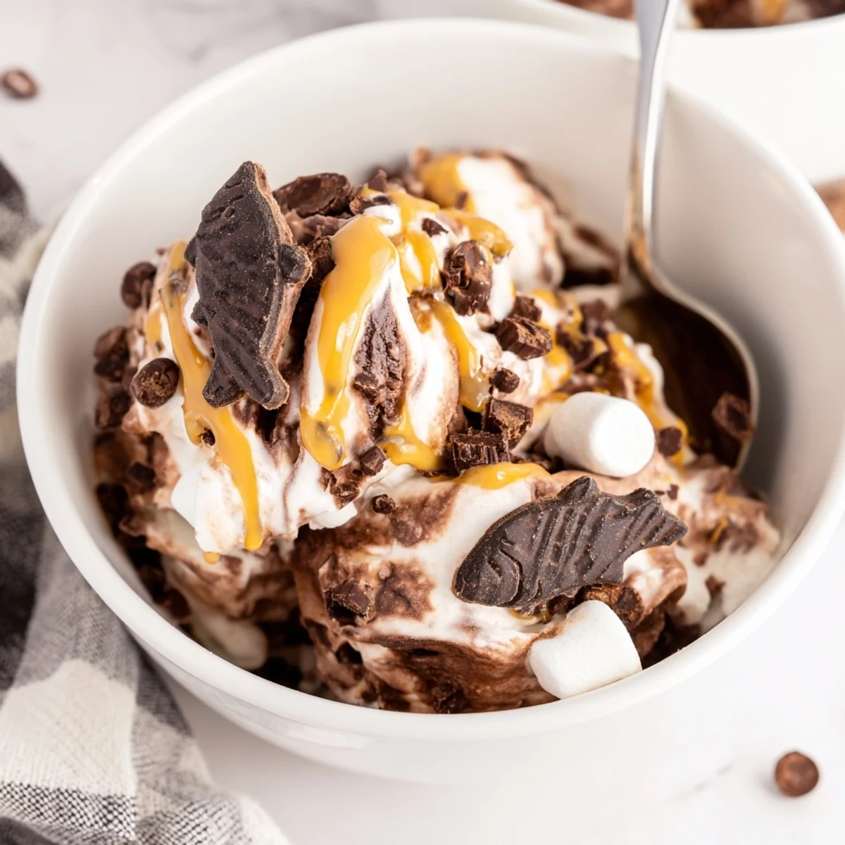 Dark chocolate Ninja Creami Phish Food ice cream featuring gooey marshmallow and caramel swirls topped with chocolate fish