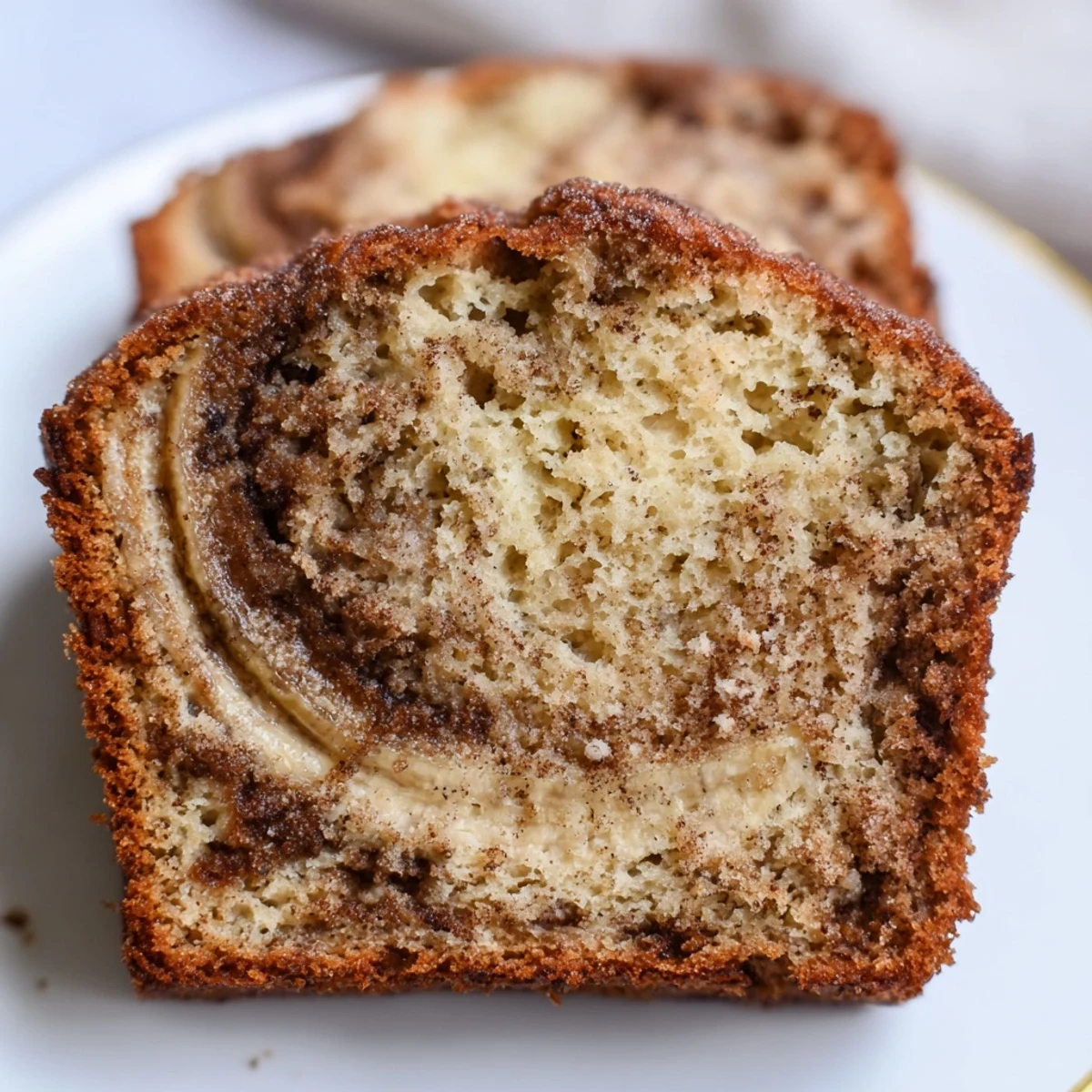 Cinnamon Sugar Swirl Banana Bread sliced thick showing marbled cinnamon ribbons throughout tender moist crumb