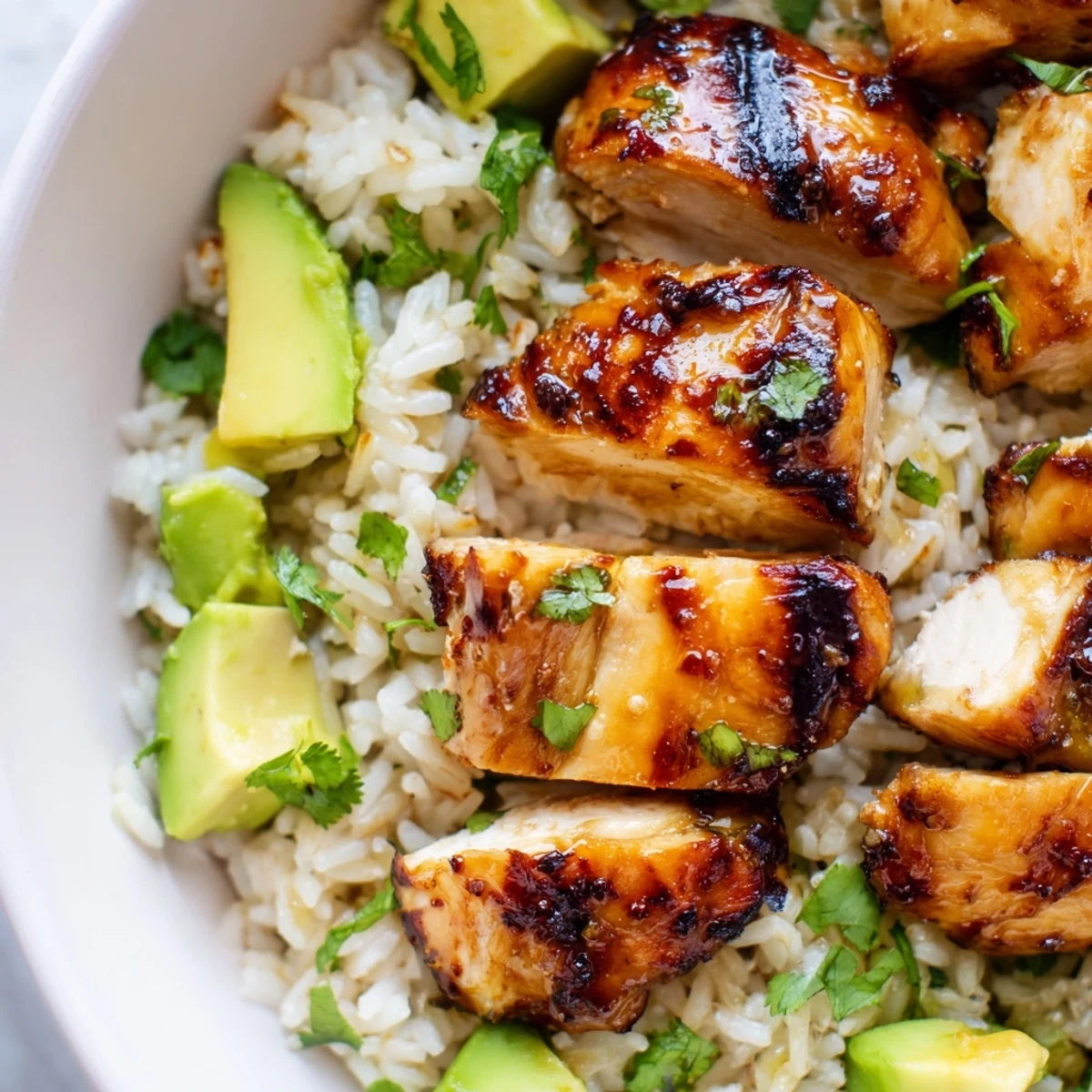 Tender glazed honey lime chicken breast resting on a bed of fluffy avocado rice