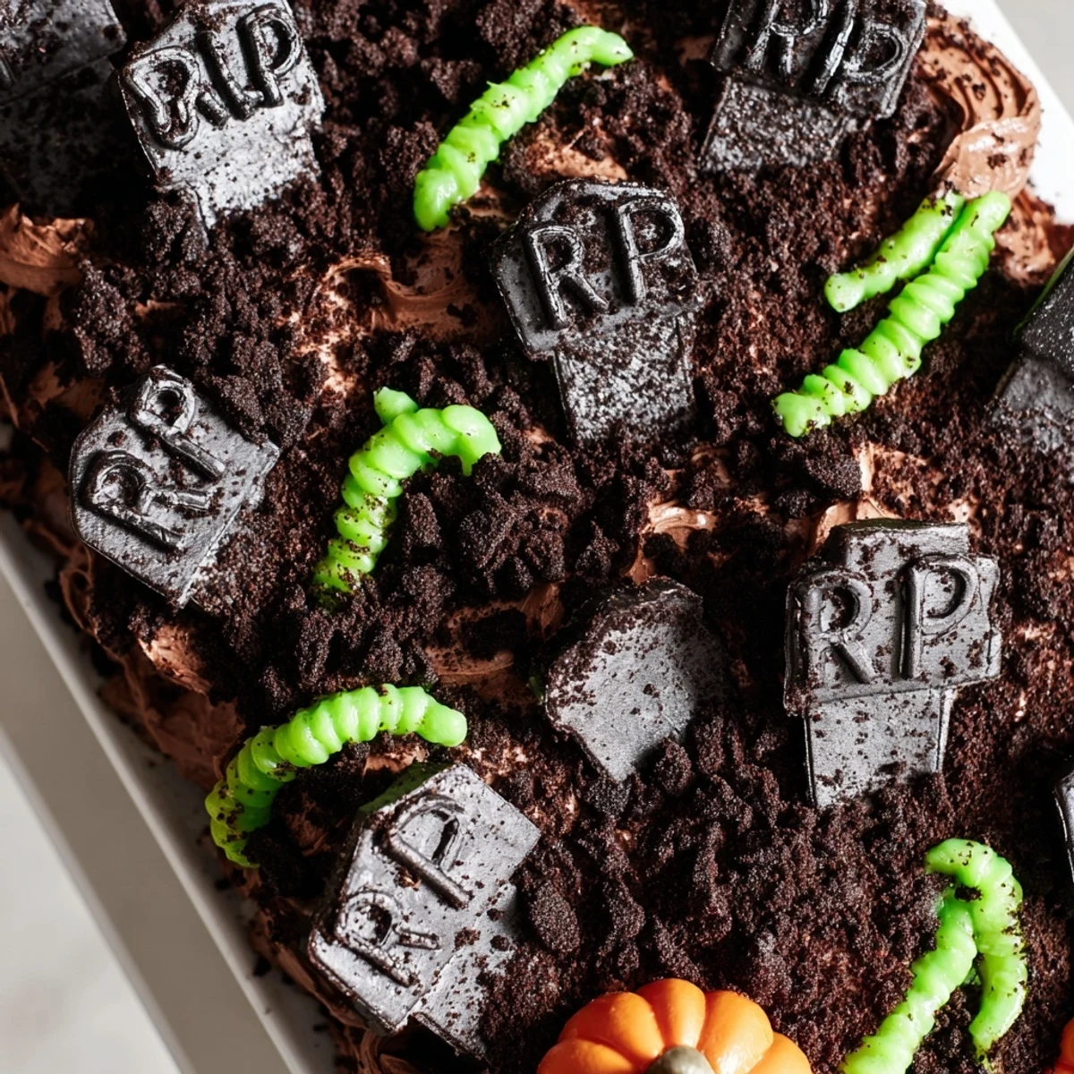 Spooky Pull Apart Graveyard Cupcakes arranged together with RIP tombstones and Halloween candy decorations