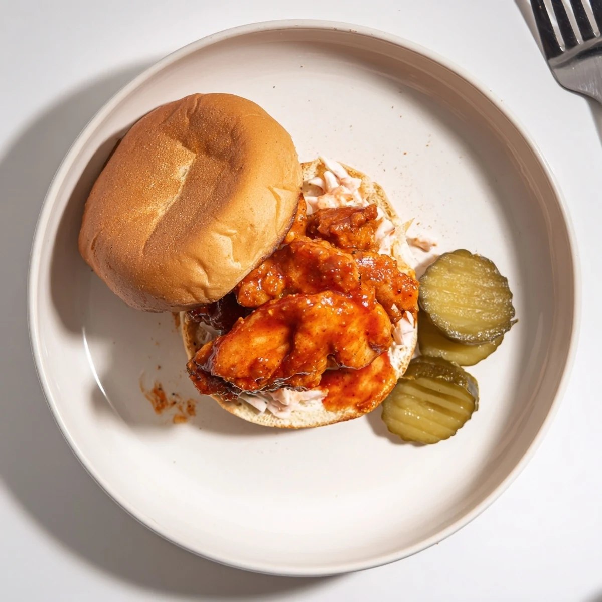 Buttered brioche holding Spicy Nashville Hot Chicken Sandwiches, juicy thighs and creamy slaw