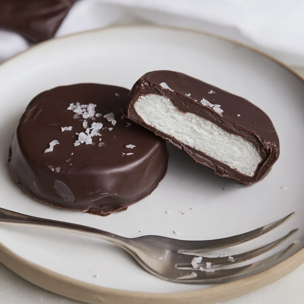 Hand-dipped Peppermint Patties cooling on parchment, rich chocolate aroma filling kitchen