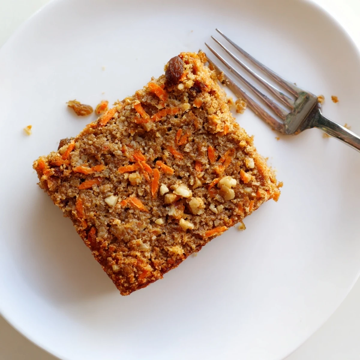Wholesome flourless carrot cake loaf dusted with cinnamon and served with fresh brewed coffee