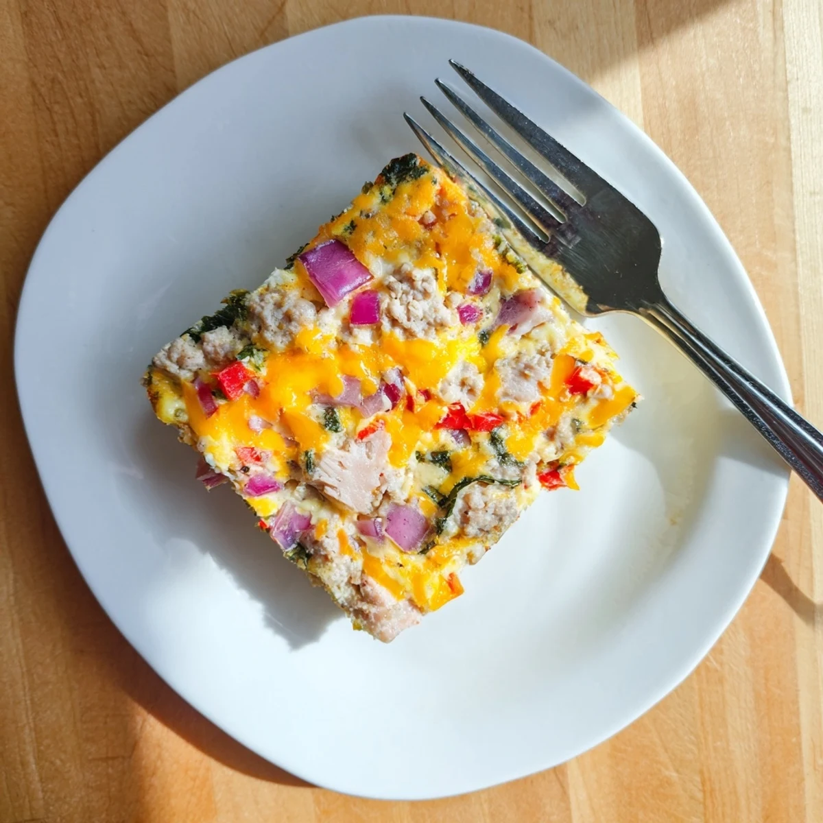 Savory egg casserole recipe featuring spinach bell peppers and shredded chicken baked to golden perfection