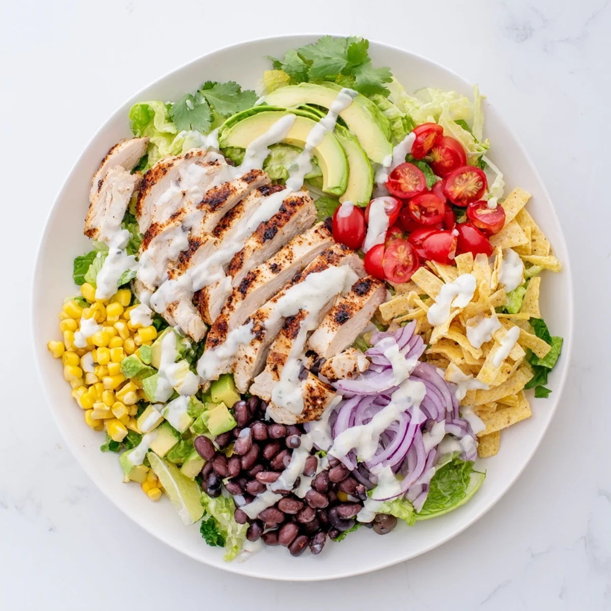 Colorful Southwestern chicken salad bowl with grilled chicken slices, black beans, corn, and creamy dressing