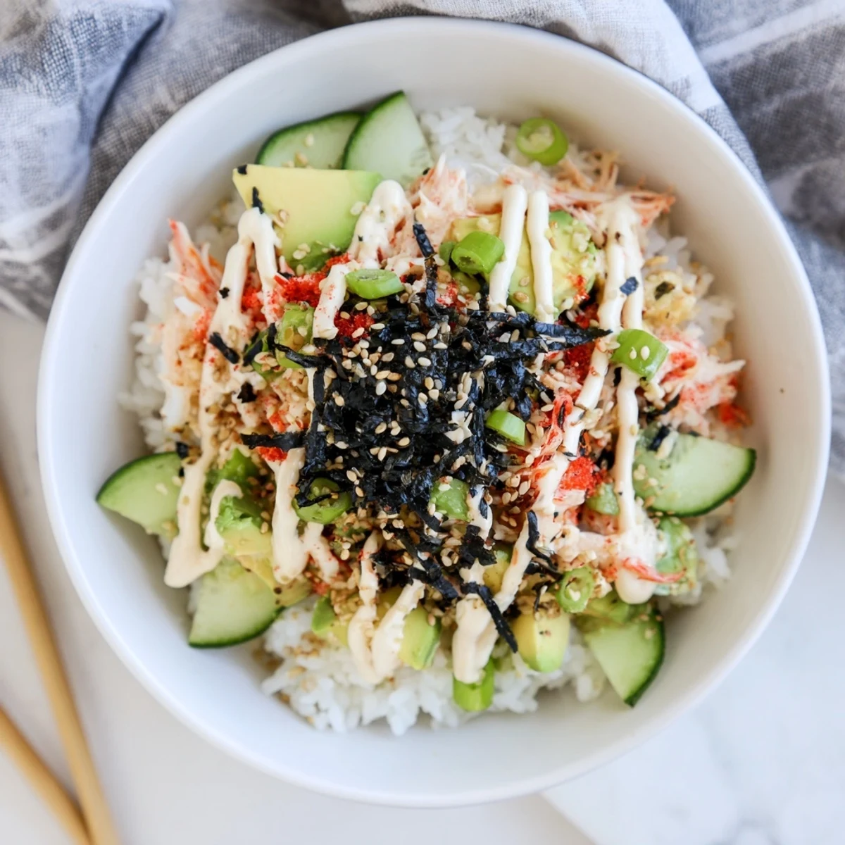 Colorful California roll sushi bowl featuring fluffy rice, avocado, cucumber, and crab