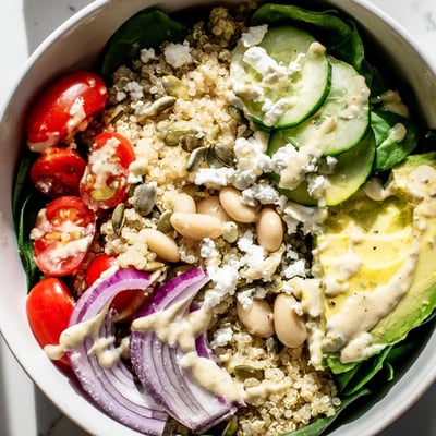 Fresh spinach and white beans in the Spinach & White Bean Ultimate Protein Power Bowl with tangy dressing.