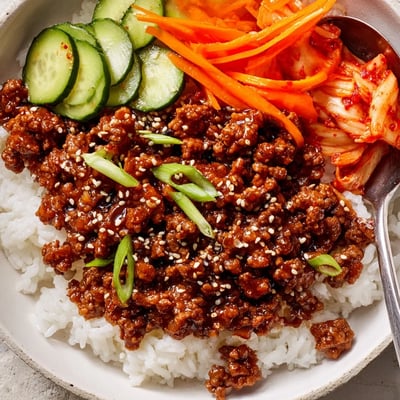 Savory Korean ground beef bowl topped with crisp vegetables and toasted sesame seeds